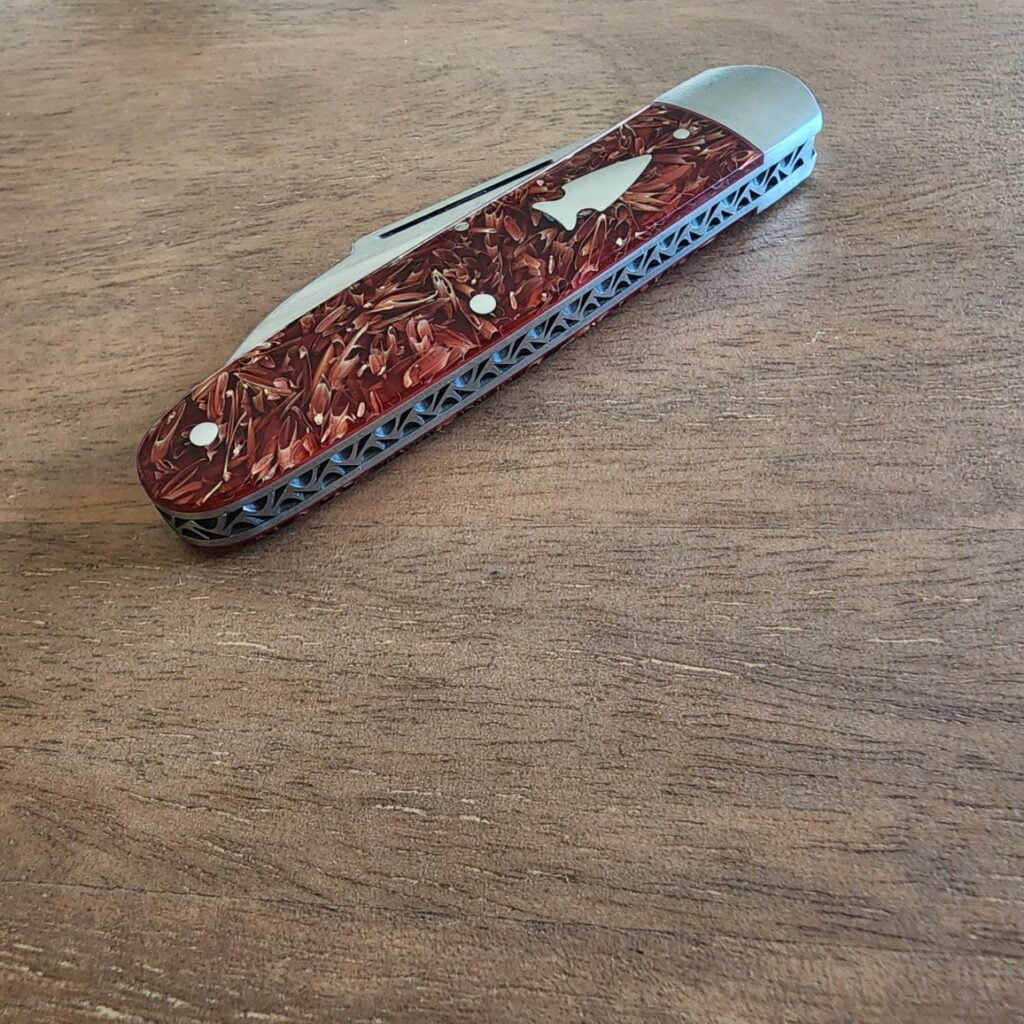 K'Roo Custom Hollow Ground Sleeveboard Wharncliffe in Red Seed Husk Resin Created April 2024 by W. O'Kelly knives for sale