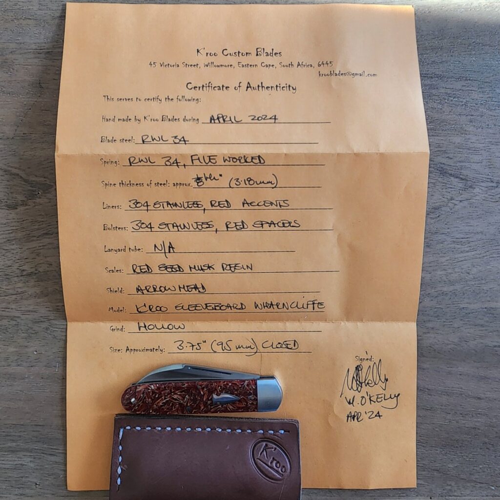 It's Official: We Sell K'roo Knives! knives for sale K'Roo Custom Hollow Ground Sleeveboard Wharncliffe in Red Seed Husk Resin Created April 2024 by W. O'Kelly knives for sale