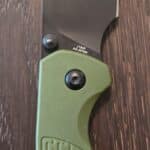 CJRB Cutlery Pyrite-Light Button Lock Folding Knife 3.34" AR-RPM9 Black Wharncliffe Blade, OD Green FRN Handles - J1945-BGN knife for sale