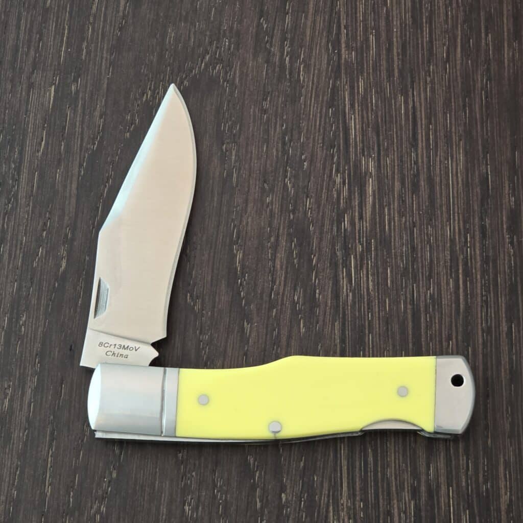 A.G. Russell Gunstock Lock back in Yellow Delrin 8CR13 MOV (please note stabilized crack at pin) – gallery image 3