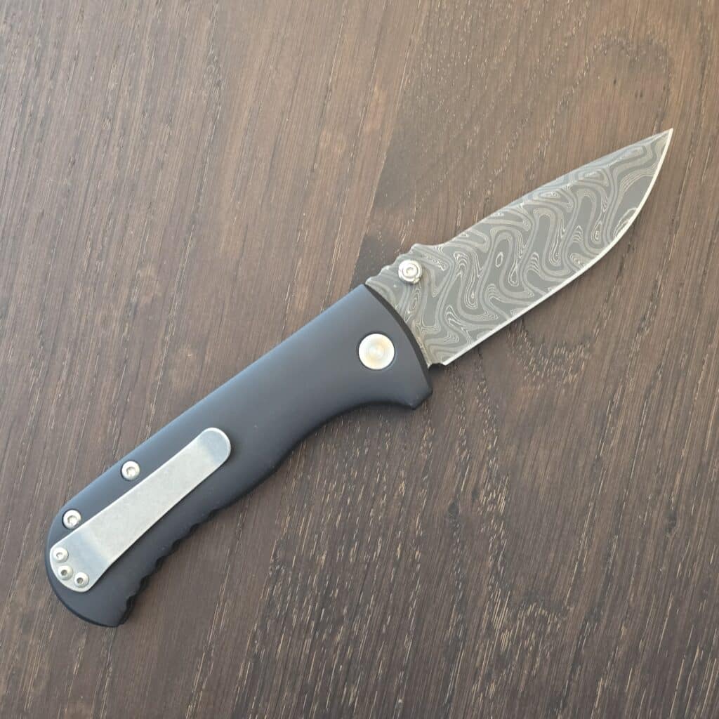 Defiant-7 Talos Button Lock with Black Boomerang Stainless Chad Nichols Damascus Blade and Black Hardcoat Anodized Aluminum Handles USA knife for sale