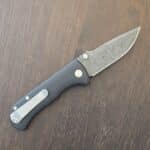 Defiant-7 Talos Button Lock with Black Boomerang Stainless Chad Nichols Damascus Blade and Black Hardcoat Anodized Aluminum Handles USA