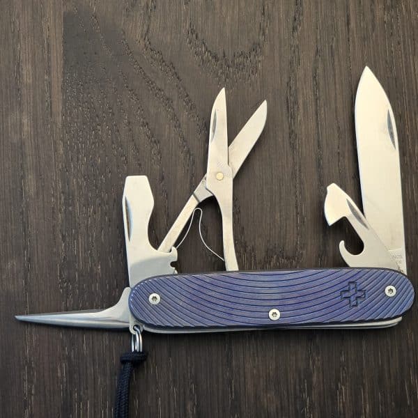 Custom Forge Custom Victorinox Pioneer X Titanium Meridians Anodized Blue Purple with Black Leather/Blue Stitching Slip and red Victorinox Pins gently used – gallery image 1