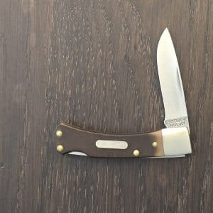 Vintage Old Timer by Schrade model 30 T lockback. 2-1/8/" stainless steel drop point blade Brown sawcut Delrin handles. Nickel bolsters. Brass dividers